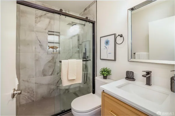 a white toilet sitting next to a bathroom sink