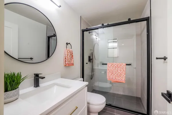 a bathroom with a sink toilet and shower