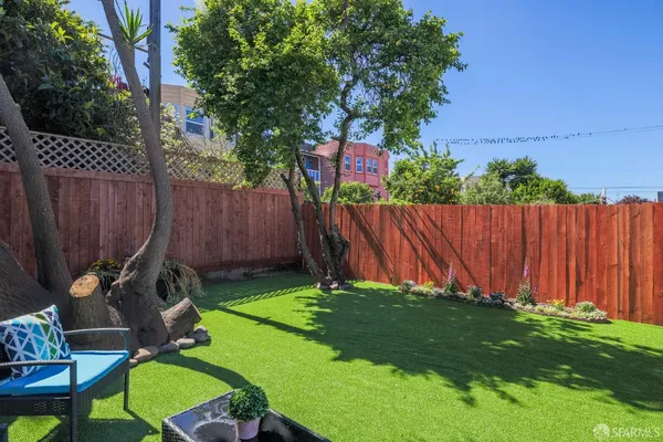 a view of yard with furniture and a fence