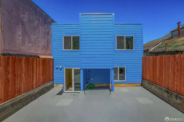 a backyard of a house with barbeque oven and yard