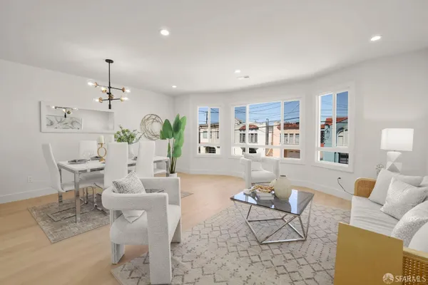 a living room with furniture and a chandelier