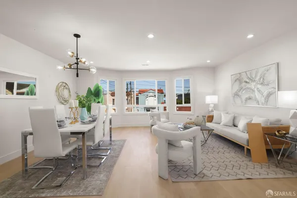 a living room with furniture and a chandelier