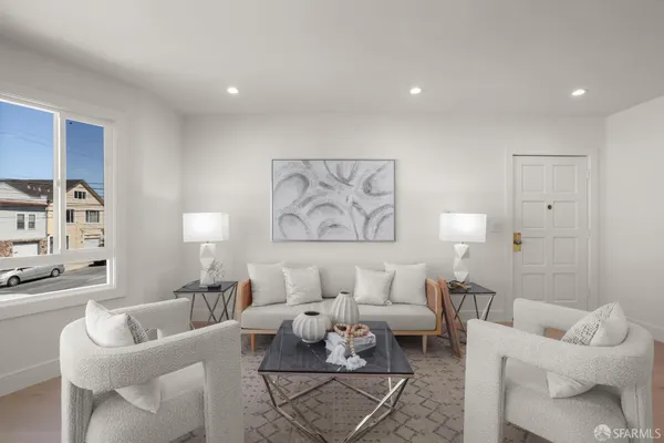 a living room with furniture and a lamp