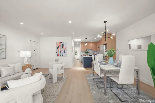a living room with furniture and a chandelier