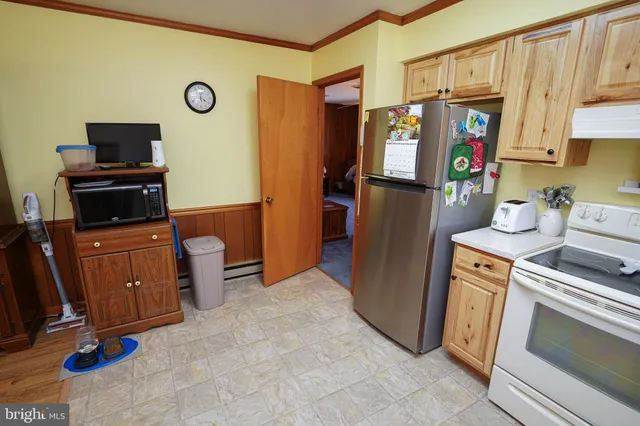 a kitchen with stainless steel appliances granite countertop a refrigerator and a stove