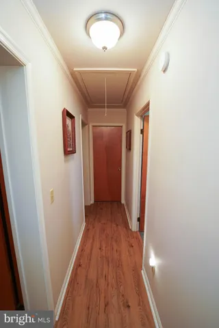 a view of a hallway with wooden floor