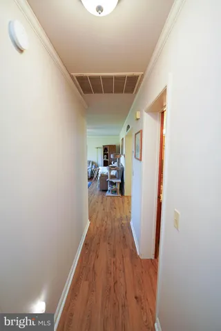 a view of a hallway and wooden floor
