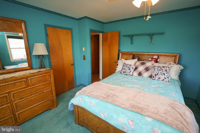 a bedroom with a bed and a dresser