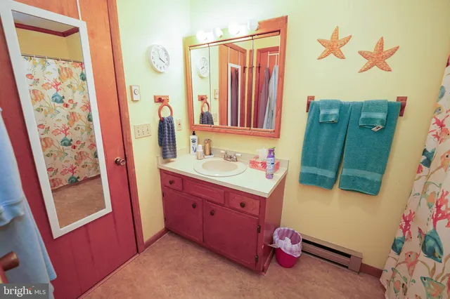 a bathroom with a sink mirror and vanity