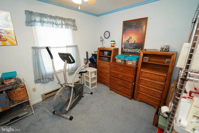 a room with furniture a flat screen tv and a window