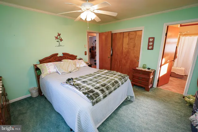 a bedroom with a bed dresser and a window