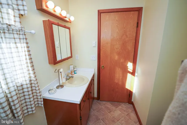 a bathroom with a toilet and a mirror