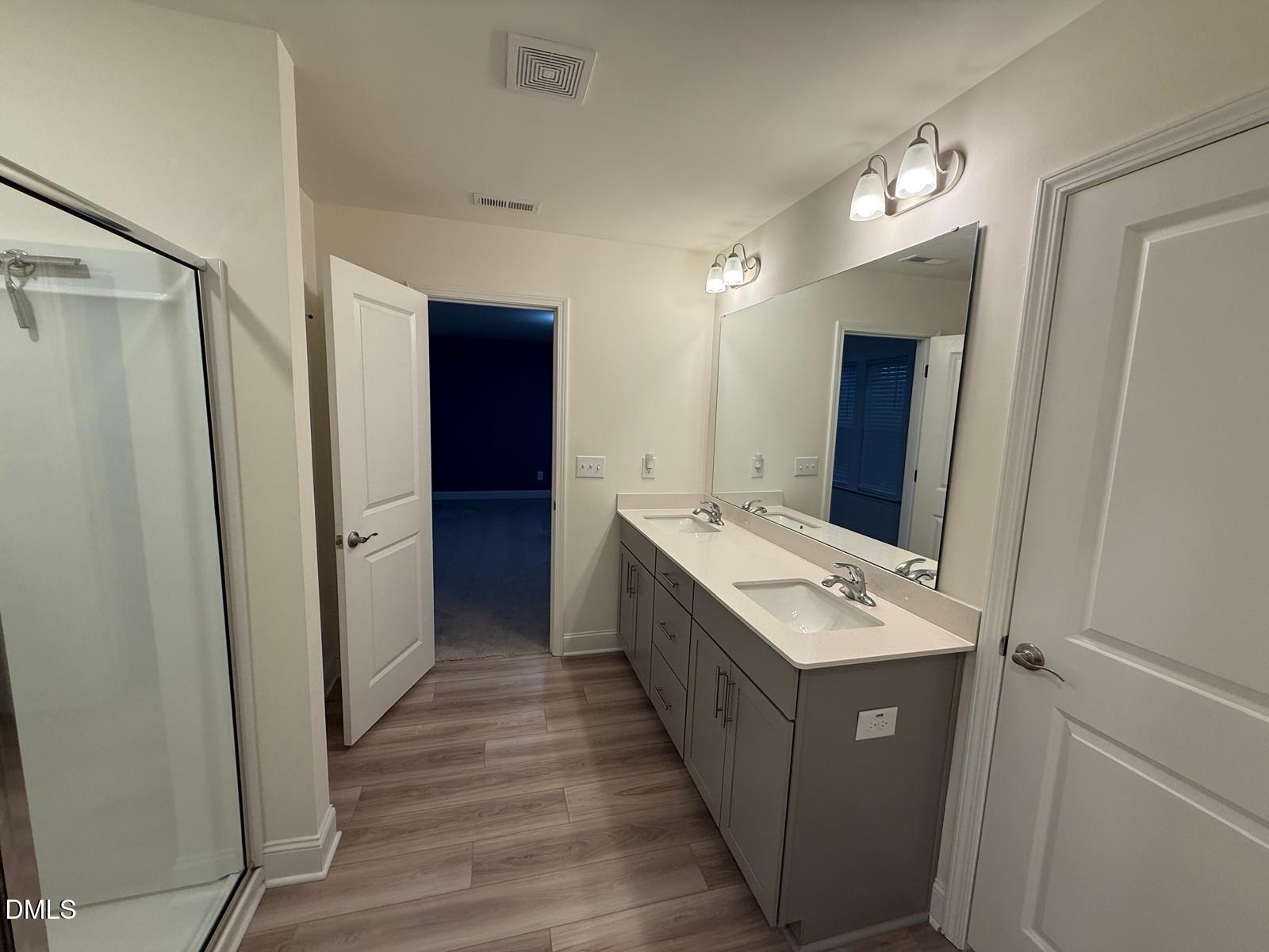 64 Nailsworth Street Angier, NC 27501 - Photo 11 of 14 a bathroom with a sink mirror and shower