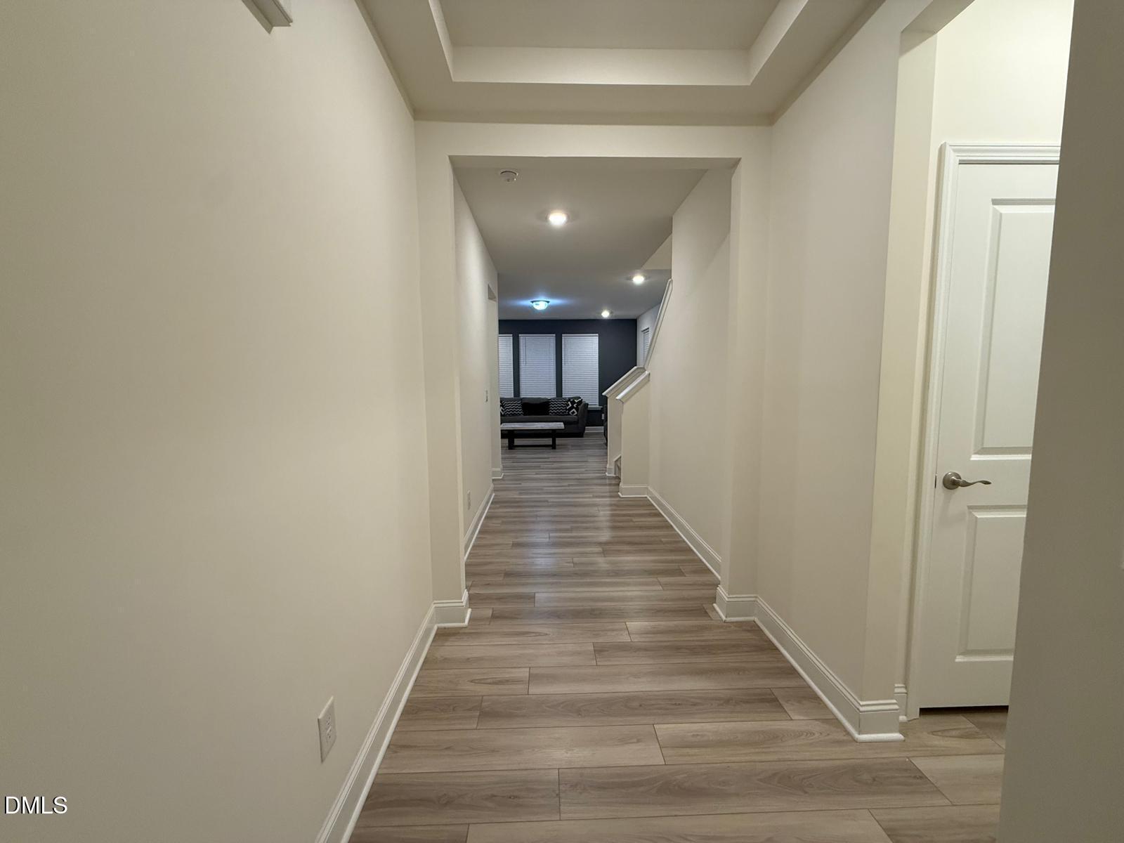 64 Nailsworth Street Angier, NC 27501 - Photo 3 of 14 a view of a hallway with wooden floor and staircase