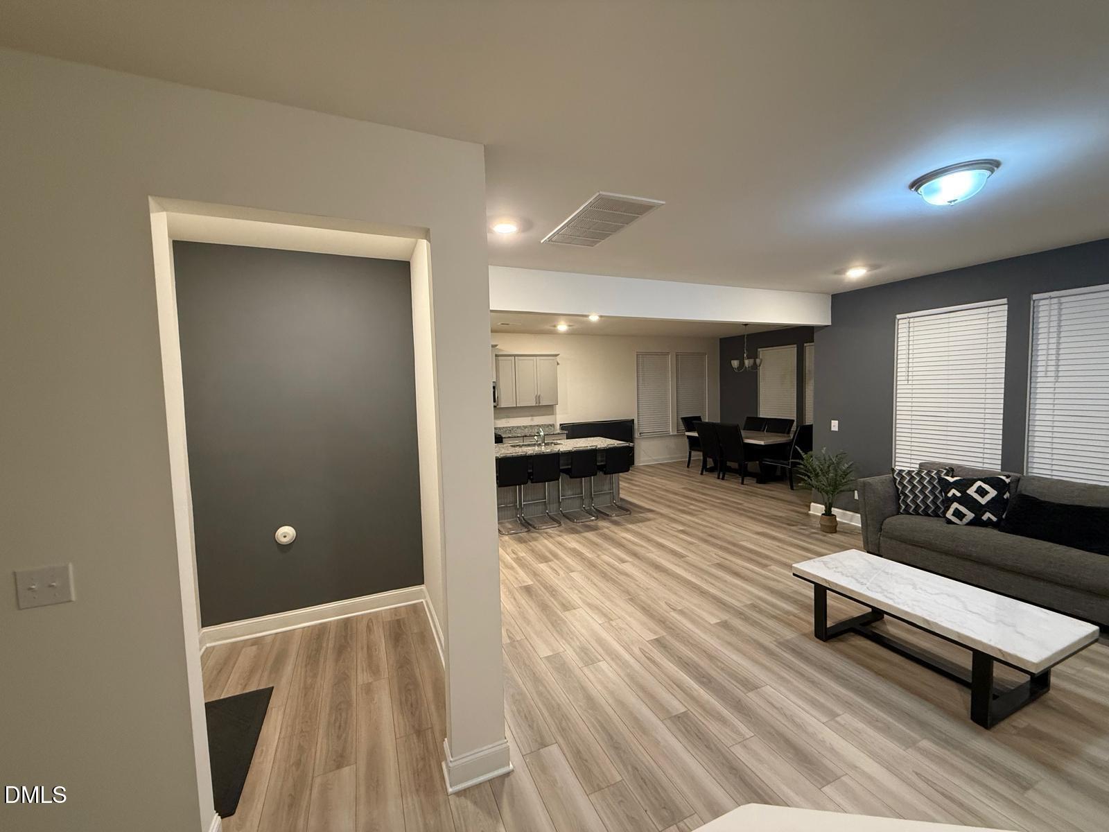 64 Nailsworth Street Angier, NC 27501 - Photo 4 of 14 a living room with furniture and a wooden floor
