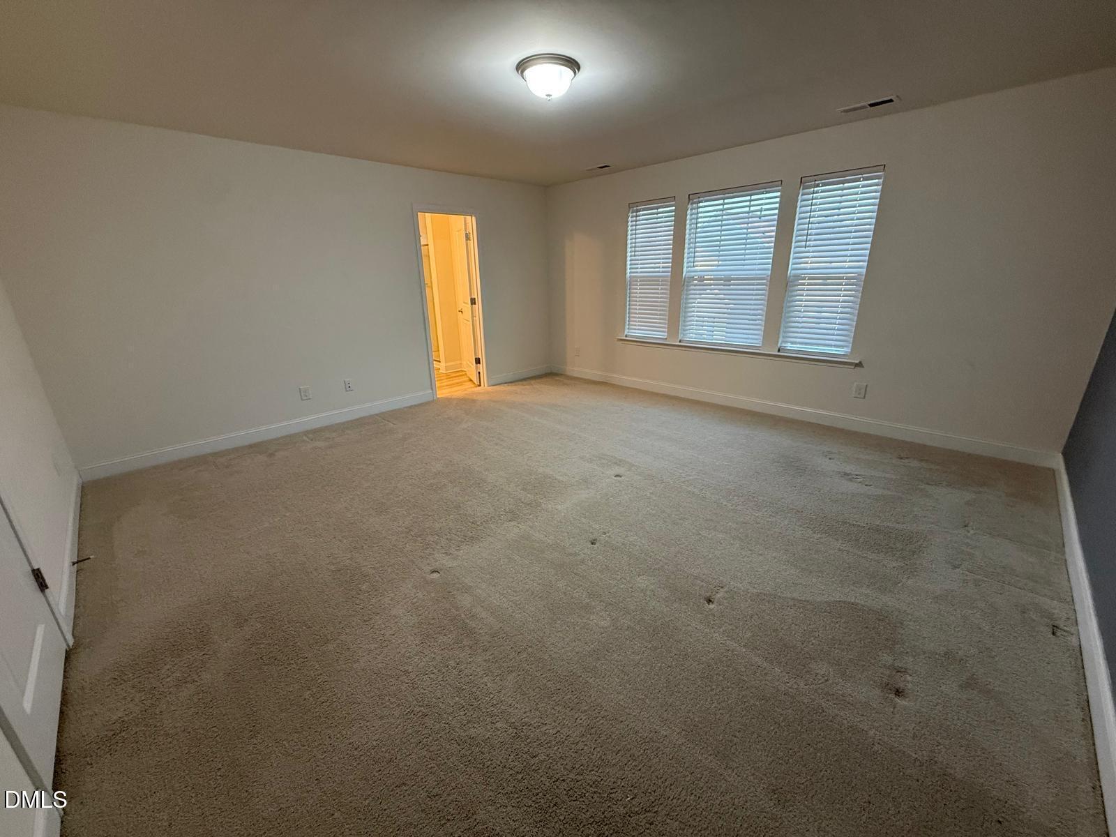 64 Nailsworth Street Angier, NC 27501 - Photo 7 of 14 an empty room with a empty space and windows