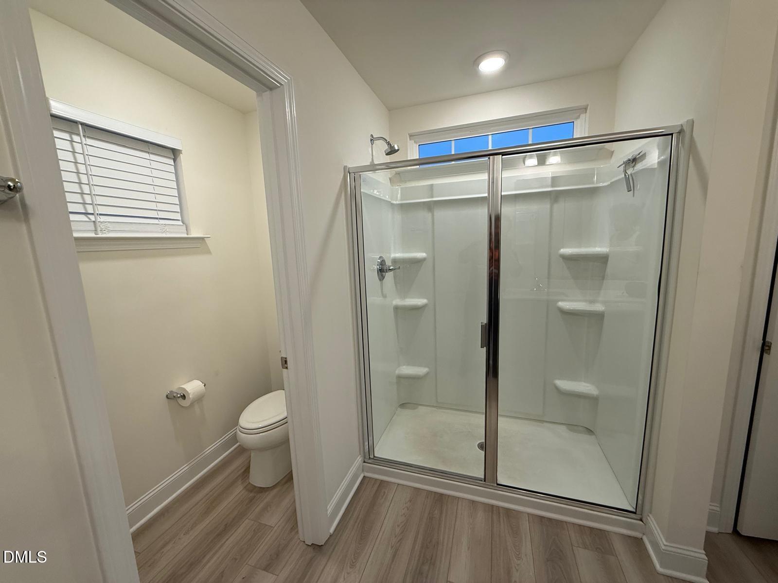 64 Nailsworth Street Angier, NC 27501 - Photo 10 of 14 a bathroom with a shower and a toilet