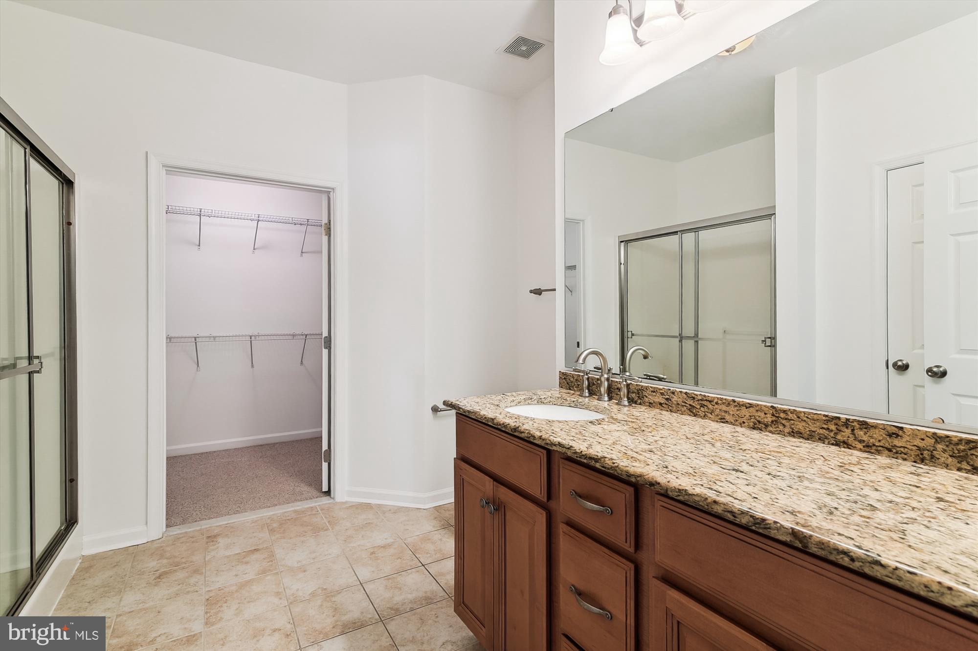36311 Ridgeshore Lane Millville, DE 19967 - Photo 16 of 36 a bathroom with a granite countertop sink and a mirror