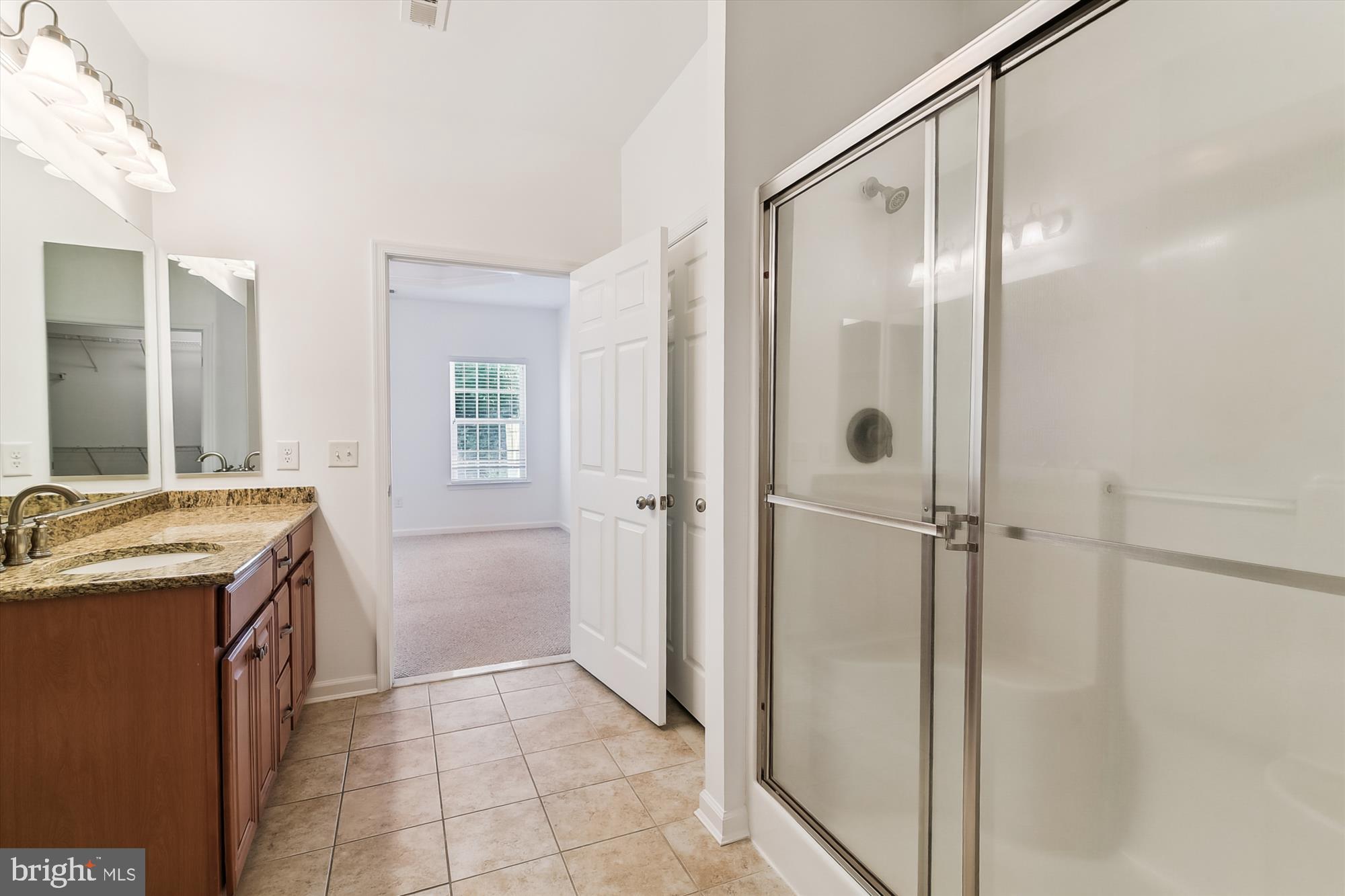 36311 Ridgeshore Lane Millville, DE 19967 - Photo 17 of 36 a bathroom with a granite countertop sink mirror and shower