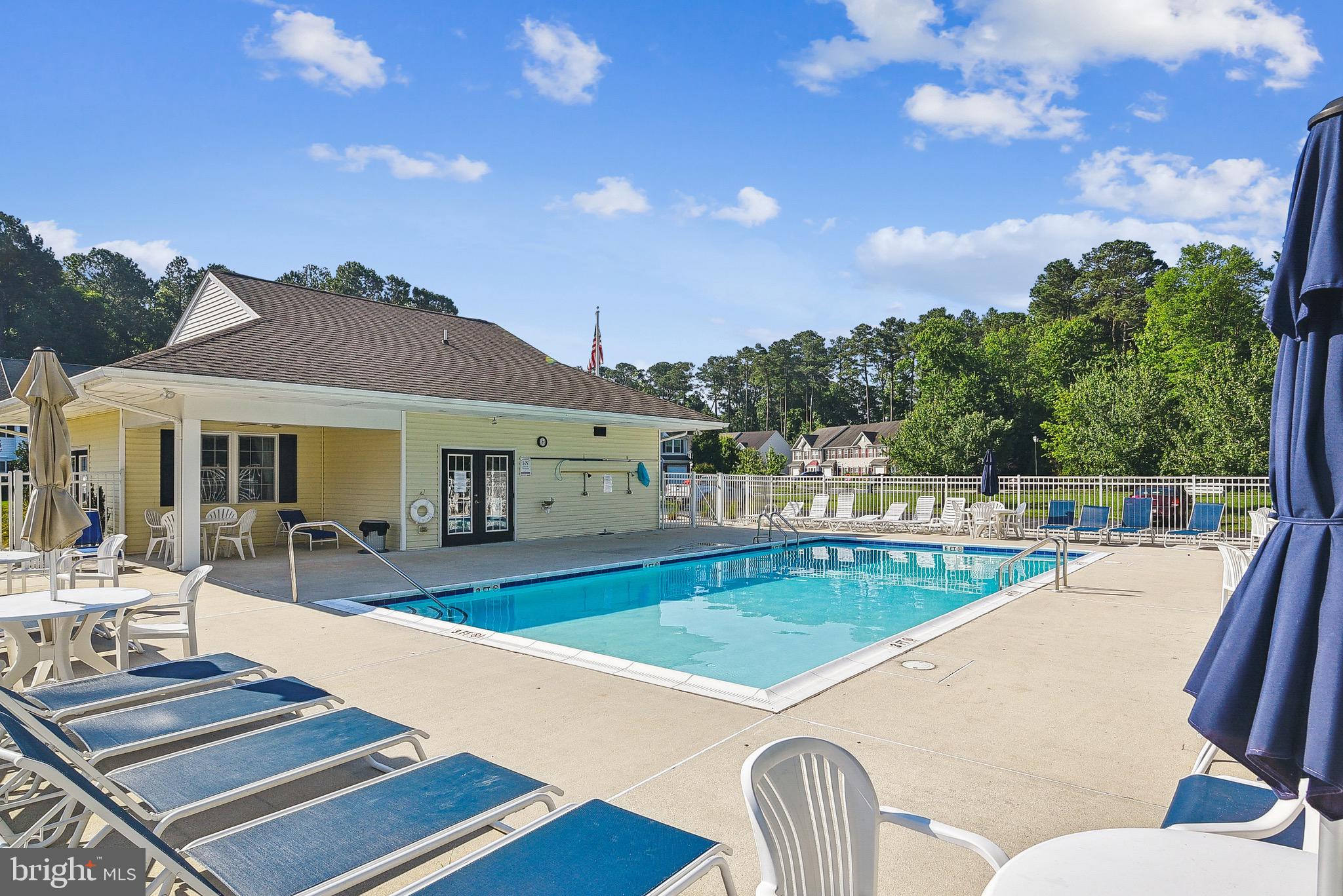 36311 Ridgeshore Lane Millville, DE 19967 - Photo 33 of 36 a view of a patio with swimming pool table and chairs