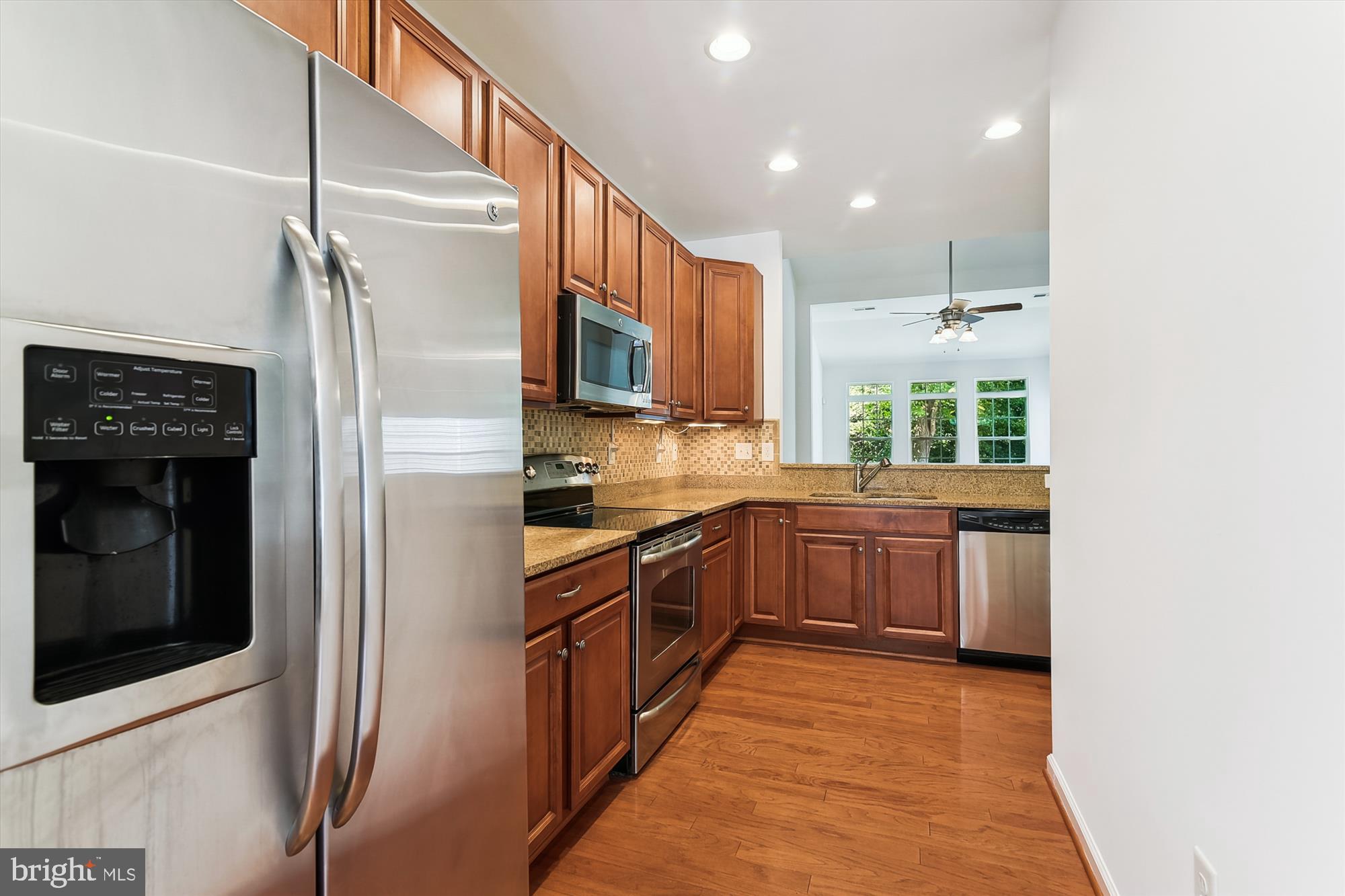 36311 Ridgeshore Lane Millville, DE 19967 - Photo 4 of 36 a kitchen with stainless steel appliances granite countertop a refrigerator and a sink