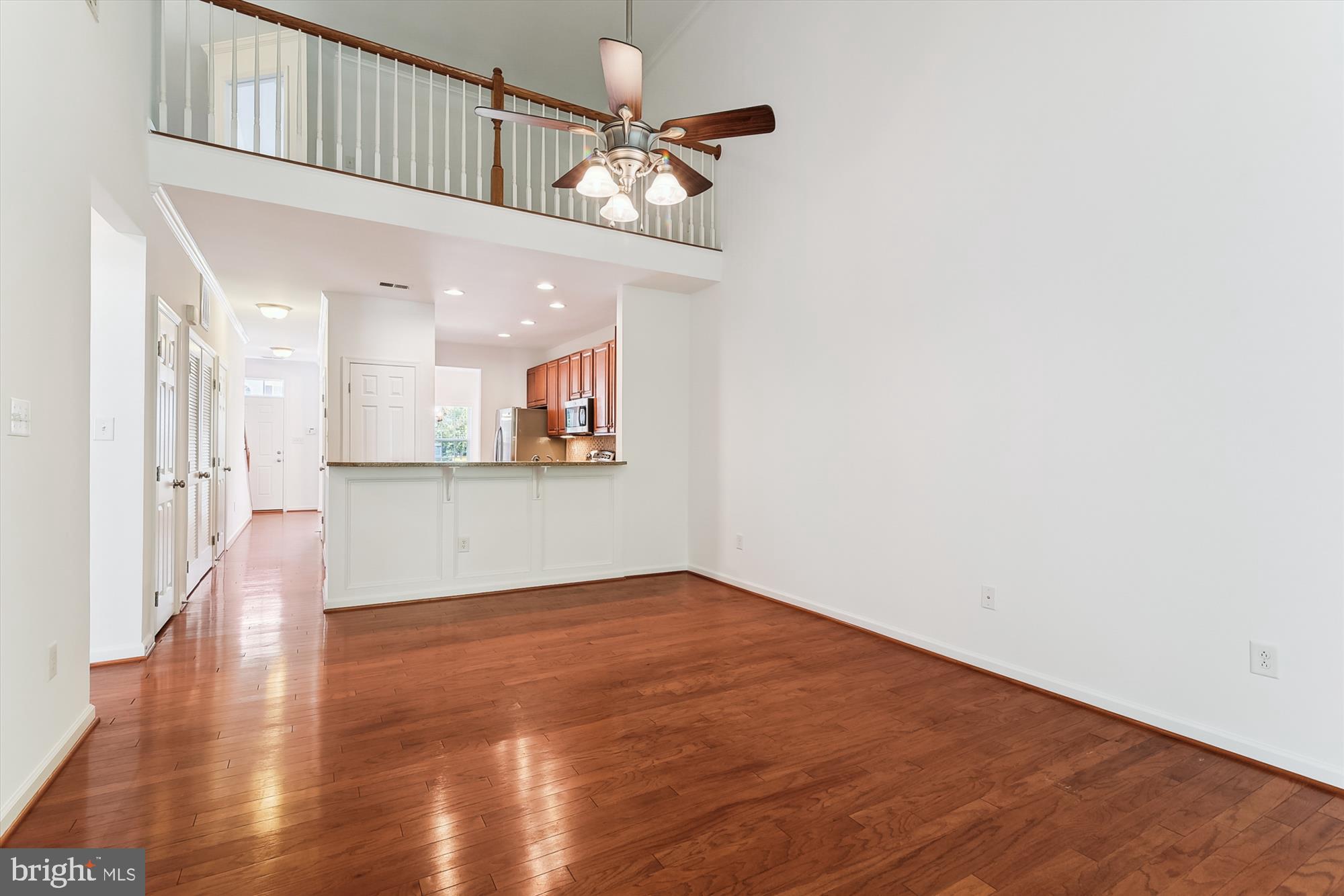 36311 Ridgeshore Lane Millville, DE 19967 - Photo 7 of 36 a view of a kitchen with wooden floor and a chandelier