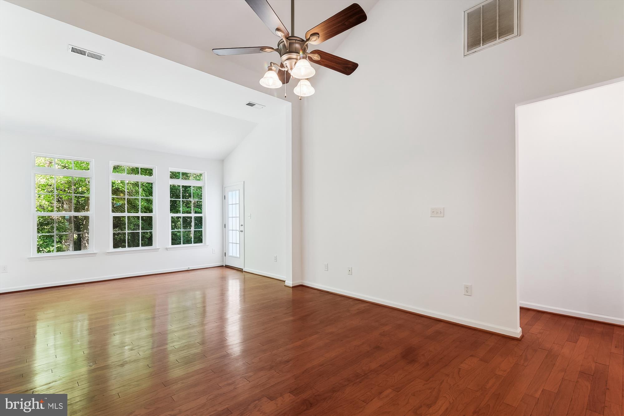 36311 Ridgeshore Lane Millville, DE 19967 - Photo 10 of 36 a view of an empty room with wooden floor and a window