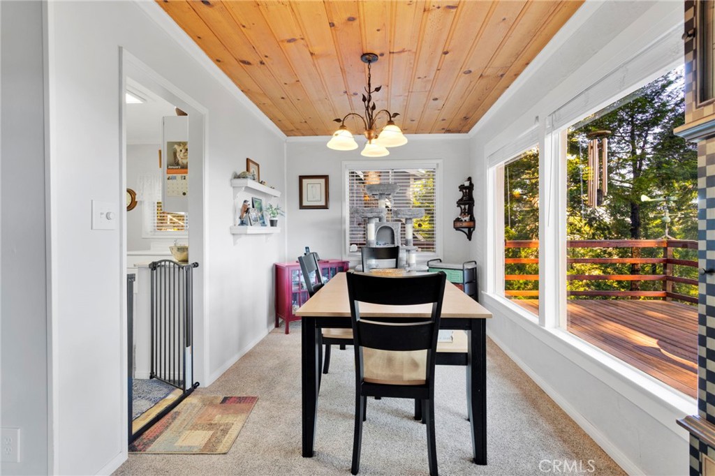 993 Mercury Way Crestline, CA 92325 - Photo 19 of 68 a view of a dining room with furniture a chandelier and large windows