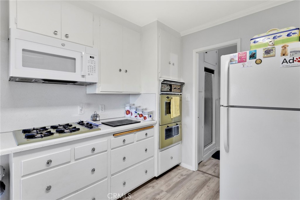 993 Mercury Way Crestline, CA 92325 - Photo 24 of 68 a kitchen with white cabinets and refrigerator