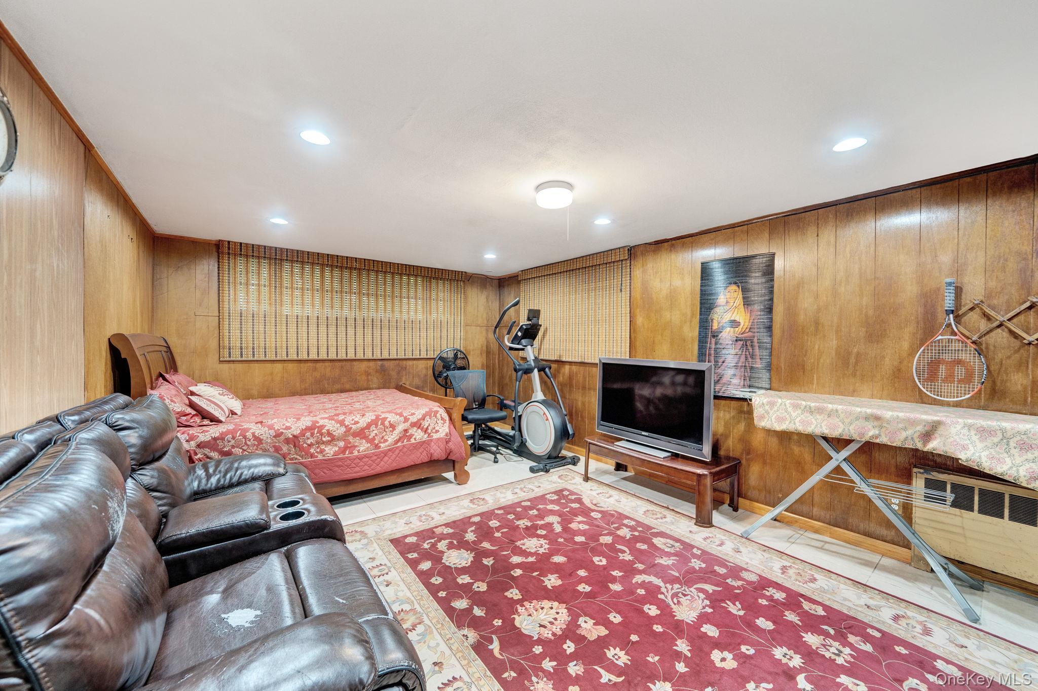 1 Wayland Road Plainview, NY 11803 - Photo 24 of 28 Bedroom with wood walls, tile patterned flooring, recessed lighting, and crown molding