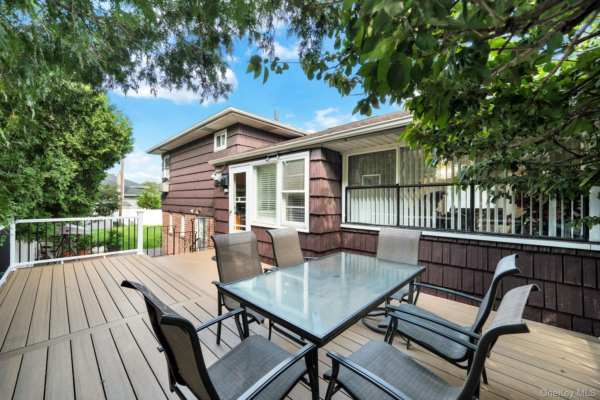 1 Wayland Road Plainview, NY 11803 - Photo 26 of 28 Wooden deck featuring outdoor dining area