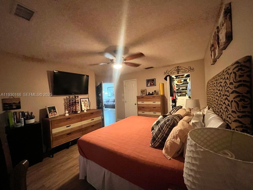 930 Southwest 109th Avenue Pembroke Pines, FL 33025 - Photo 11 of 21 a bedroom with a bed and a flat screen tv