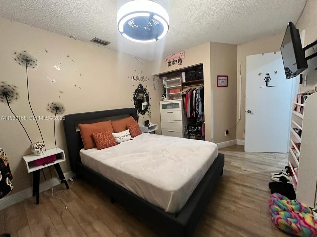 930 Southwest 109th Avenue Pembroke Pines, FL 33025 - Photo 13 of 21 a bed room with a bed and a flat screen tv