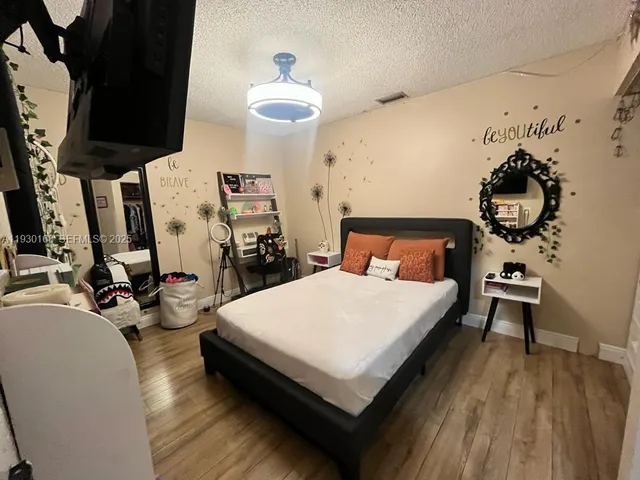 a bed room with a bed and a night stand