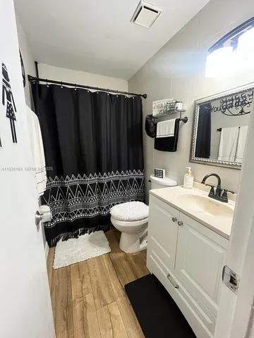 a bathroom with a sink a toilet and mirror