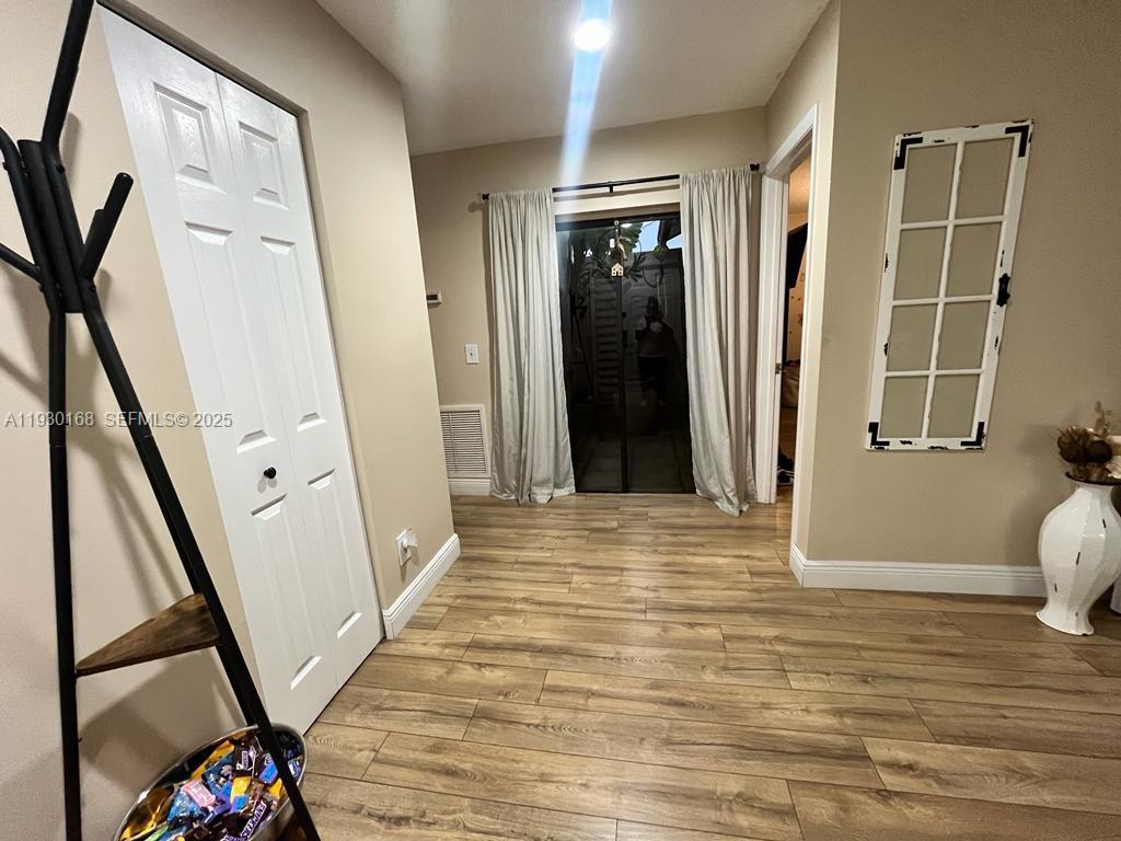 930 Southwest 109th Avenue Pembroke Pines, FL 33025 - Photo 16 of 21 a view of a hallway with wooden floor and staircase