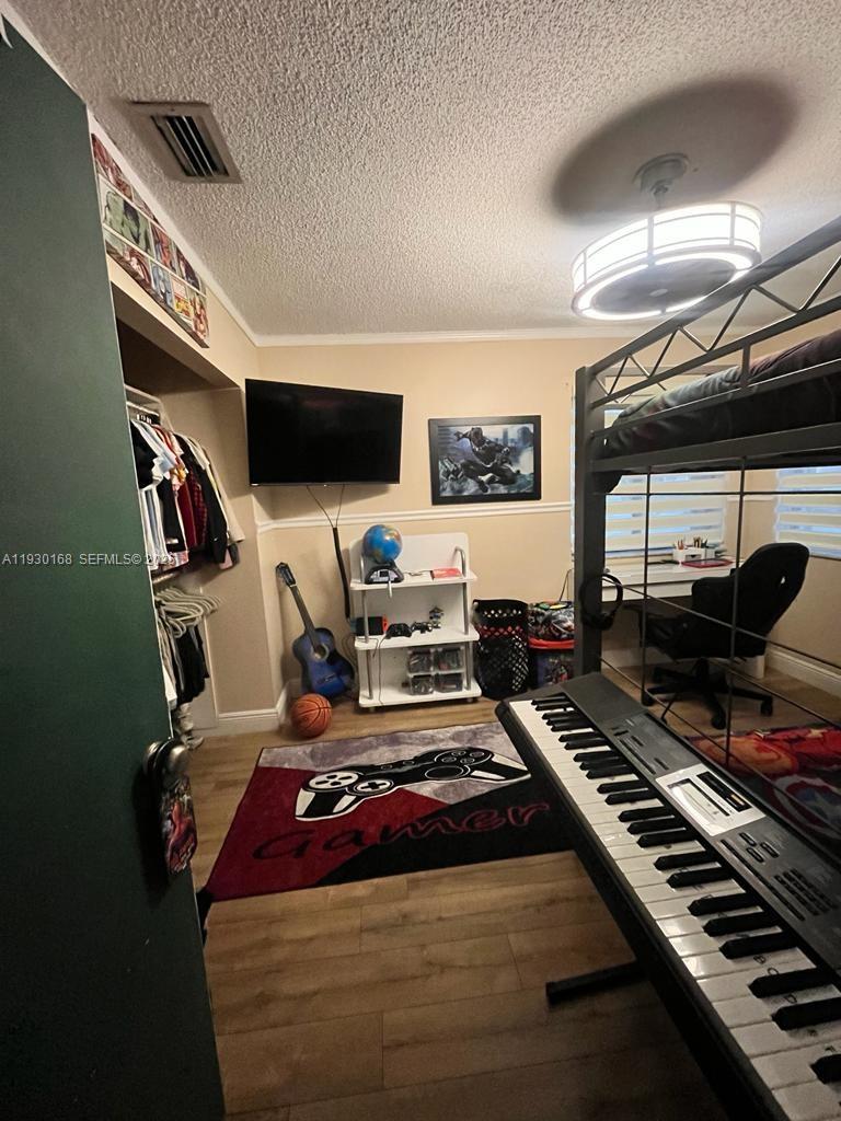 930 Southwest 109th Avenue Pembroke Pines, FL 33025 - Photo 18 of 21 a room with furniture and a flat screen tv