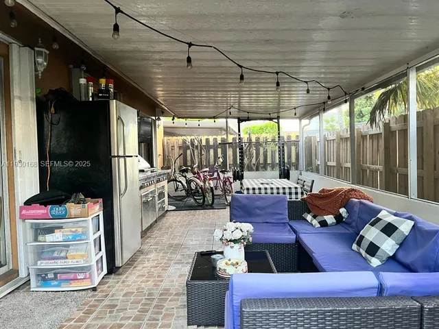 a outdoor space with patio couches and a dining table with the garden view