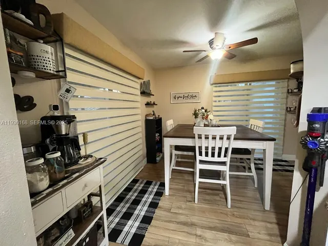 a dining room with furniture and wooden floor