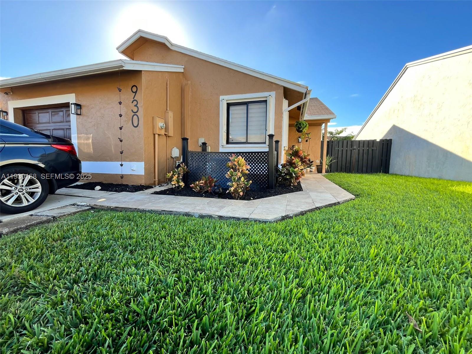 930 Southwest 109th Avenue Pembroke Pines, FL 33025 - Photo 3 of 21 a front view of a house with garden