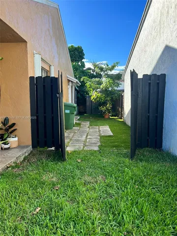a view of a backyard with potted plants