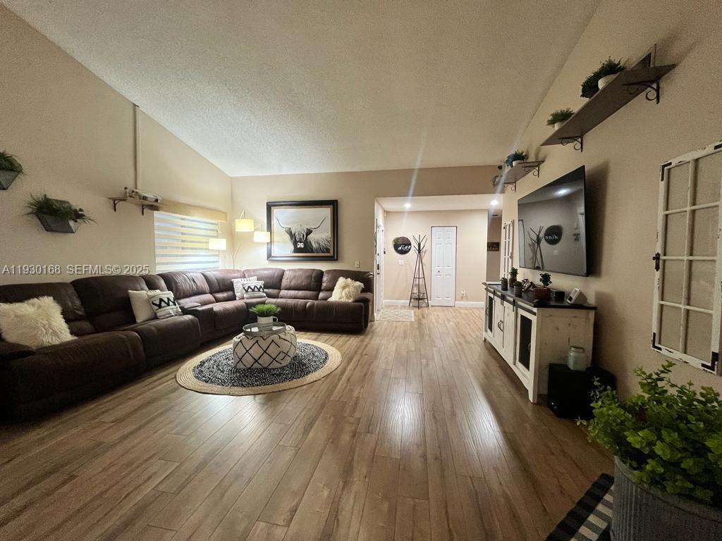 930 Southwest 109th Avenue Pembroke Pines, FL 33025 - Photo 9 of 21 a living room with furniture and a wooden floor