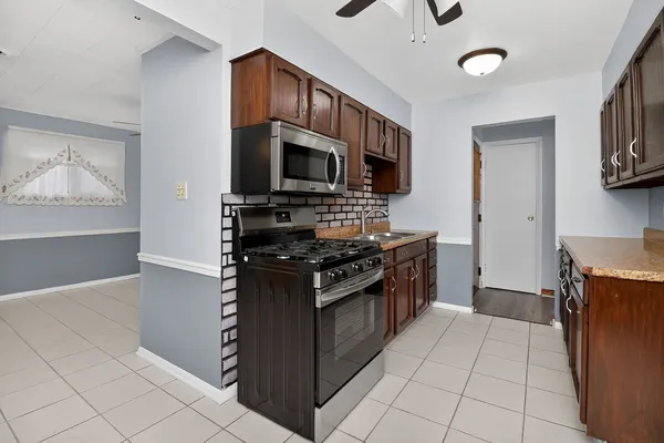 a kitchen with stainless steel appliances granite countertop a stove and a microwave