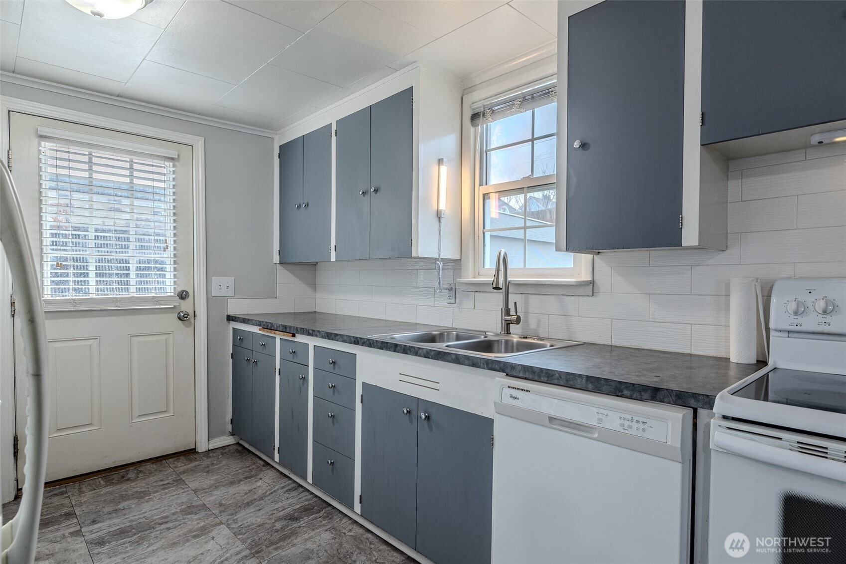 246 North Delaware Avenue Wenatchee, WA 98801 - Photo 8 of 24 a kitchen with a sink stove and cabinets
