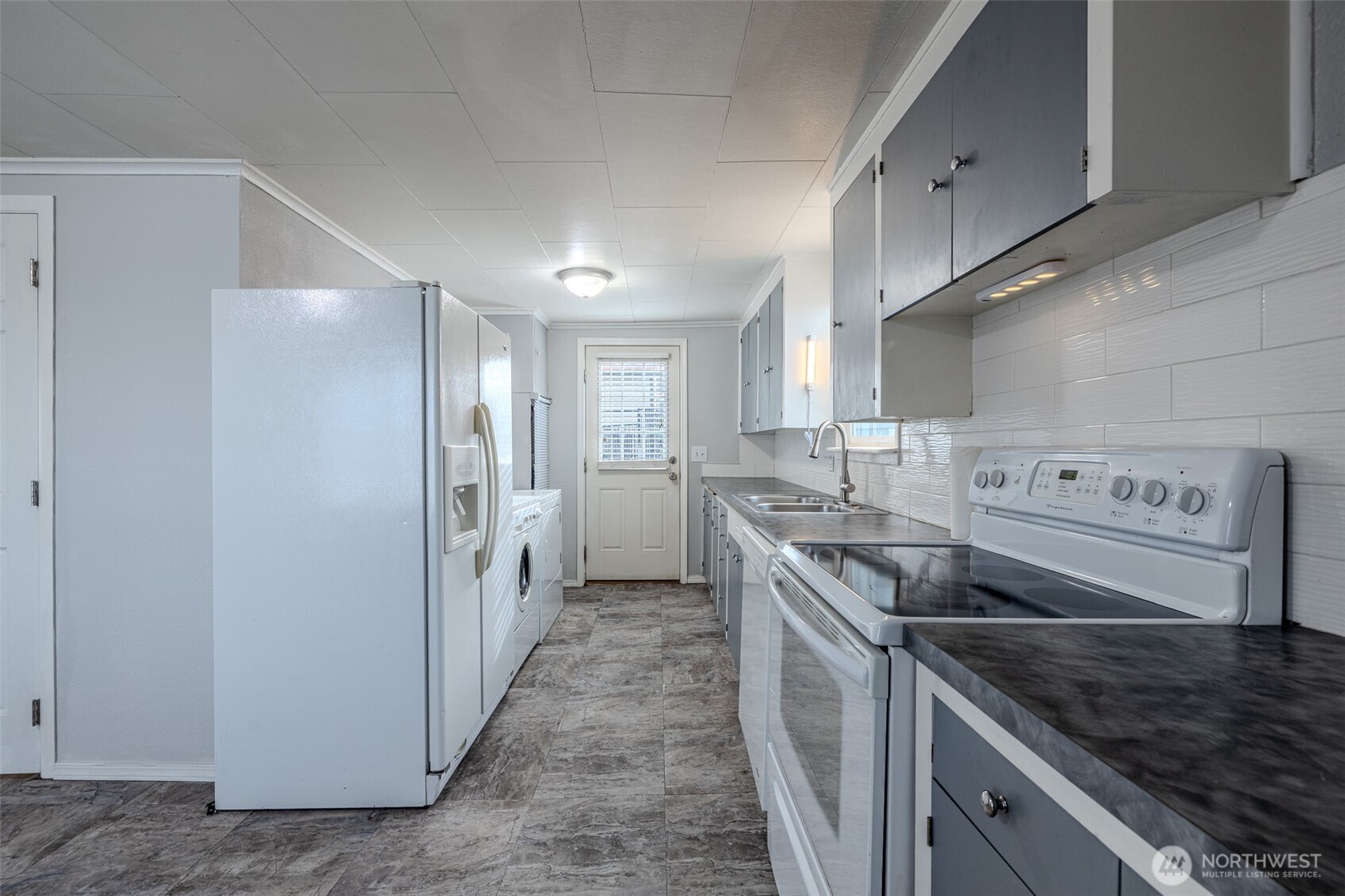 246 North Delaware Avenue Wenatchee, WA 98801 - Photo 9 of 26 a kitchen with a sink stove and refrigerator