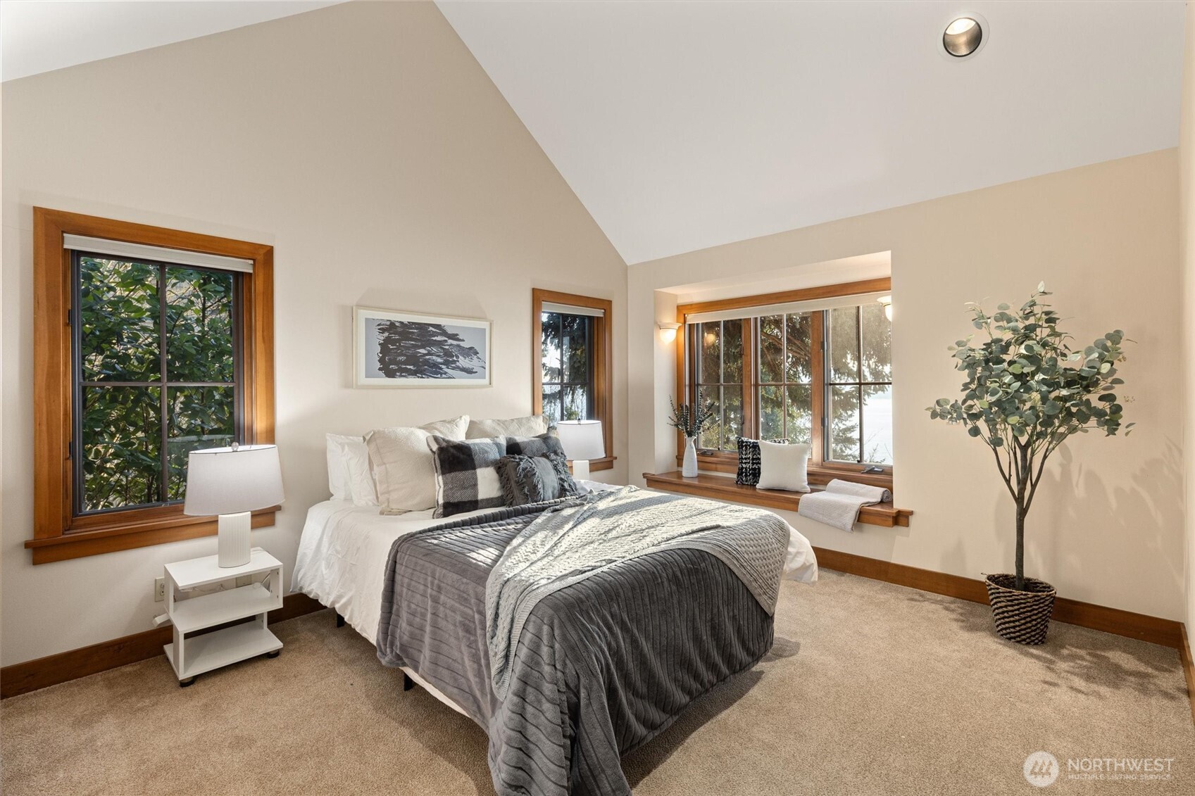 8281 West Mercer Way Mercer Island, WA 98040 - Photo 27 of 38 a bedroom with a large bed and a potted plant