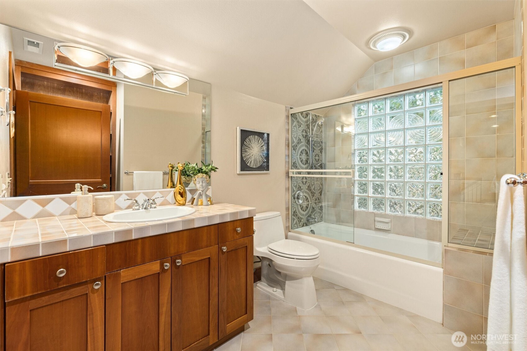 8281 West Mercer Way Mercer Island, WA 98040 - Photo 29 of 38 a bathroom with a sink a toilet and shower