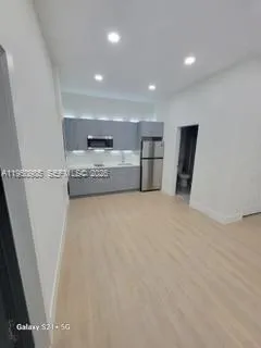 a view of kitchen and refrigerator