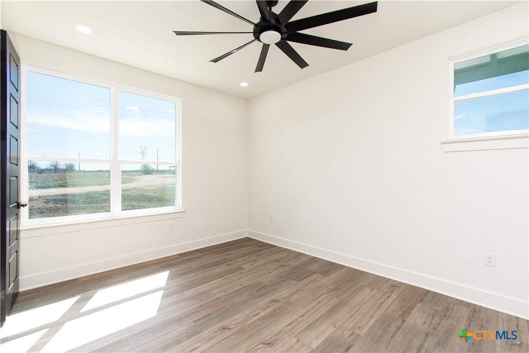 4245 Stringtown Road Temple, TX 76501 - Photo 21 of 25 an empty room with a window and a ceiling fan