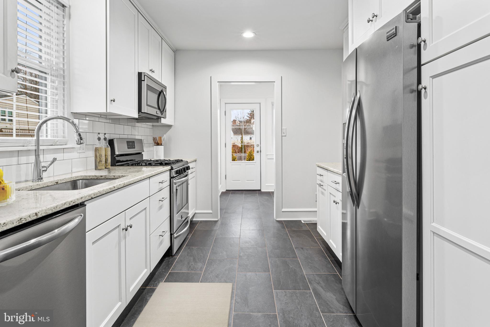 312 South Devon Avenue Wayne, PA 19087 - Photo 13 of 38 a kitchen with stainless steel appliances granite countertop a refrigerator and a sink